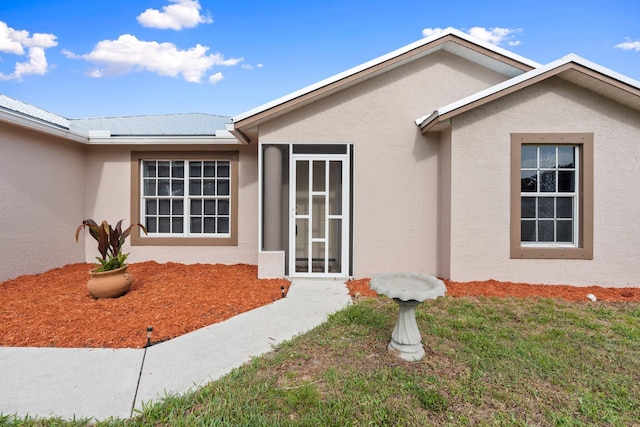 5609 Sunset Blvd, Fort Pierce, FL 34982 - property entrance with stucco siding and a yard