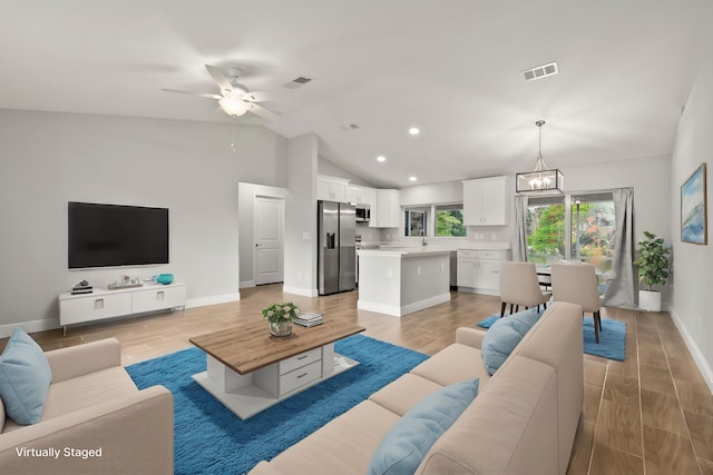 5609 Sunset Blvd, Fort Pierce, FL 34982 - living room with light wood-type flooring, vaulted ceiling, a chandelier, baseboards, and recessed lighting