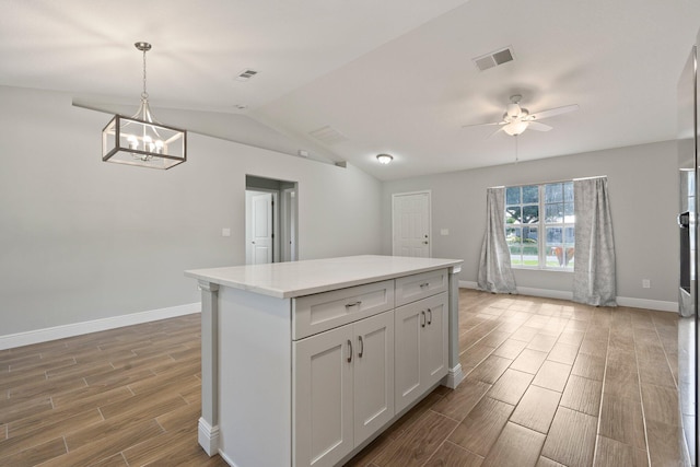 5609 Sunset Blvd, Fort Pierce, FL 34982 - kitchen with light wood-style floors, baseboards, a ceiling fan, a chandelier, and lofted ceiling