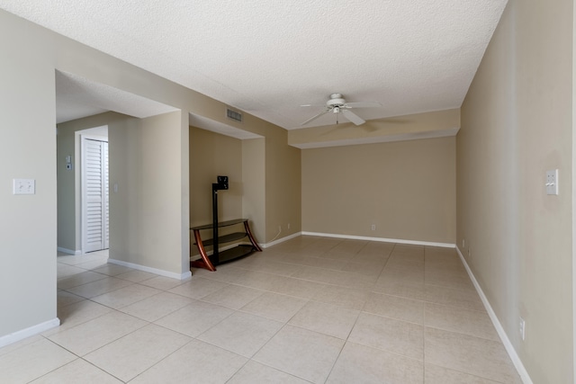 9717 Sills Dr E Unit 103, Boynton Beach, FL 33437 - unfurnished room featuring a ceiling fan, light tile patterned floors, a textured ceiling, and baseboards