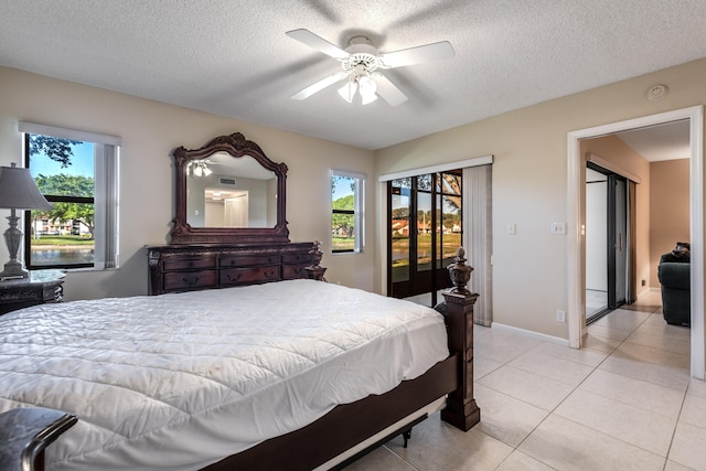 9717 Sills Dr E Unit 103, Boynton Beach, FL 33437 - bedroom with multiple windows, access to exterior, a textured ceiling, light tile patterned flooring, and a ceiling fan