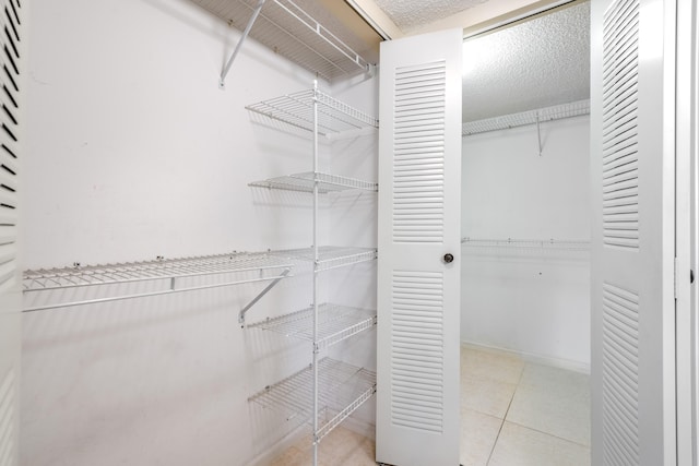 9717 Sills Dr E Unit 103, Boynton Beach, FL 33437 - walk in closet with tile patterned floors