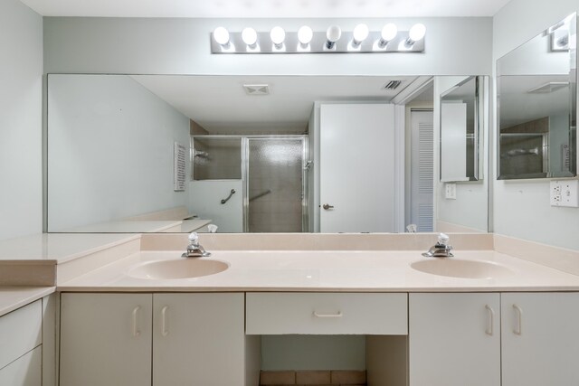 9717 Sills Dr E Unit 103, Boynton Beach, FL 33437 - bathroom featuring double vanity and a stall shower