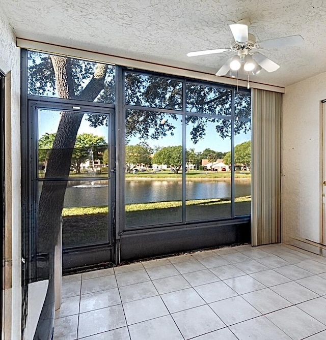 9717 Sills Dr E Unit 103, Boynton Beach, FL 33437 - unfurnished room with a water view, ceiling fan, healthy amount of natural light, and a textured ceiling