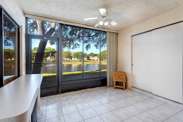 9717 Sills Dr E Unit 103, Boynton Beach, FL 33437 - unfurnished sunroom featuring a ceiling fan, a water view, and plenty of natural light