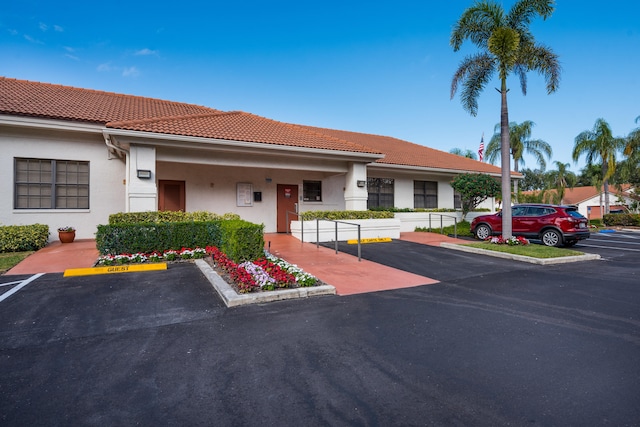 9717 Sills Dr E Unit 103, Boynton Beach, FL 33437 - view of building exterior with uncovered parking