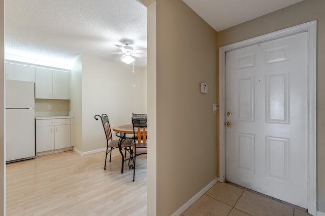 9717 Sills Dr E Unit 103, Boynton Beach, FL 33437 - entrance foyer with ceiling fan, baseboards, and a textured ceiling