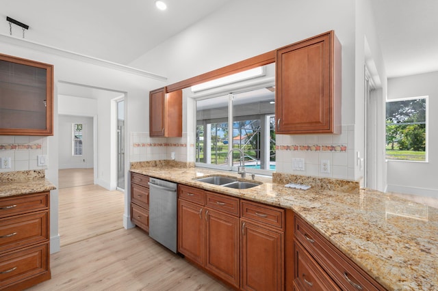 2707 SE Rawlings Rd, Port Saint Lucie, FL 34952 - kitchen featuring stainless steel dishwasher, a sink, tasteful backsplash, light wood-type flooring, and recessed lighting