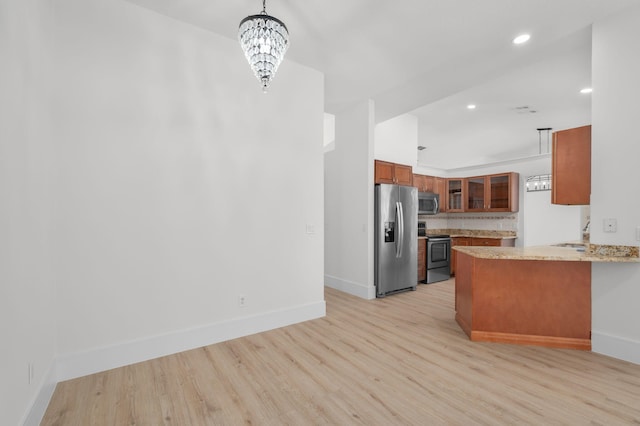 2707 SE Rawlings Rd, Port Saint Lucie, FL 34952 - kitchen featuring appliances with stainless steel finishes, brown cabinetry, baseboards, light wood-style floors, and recessed lighting