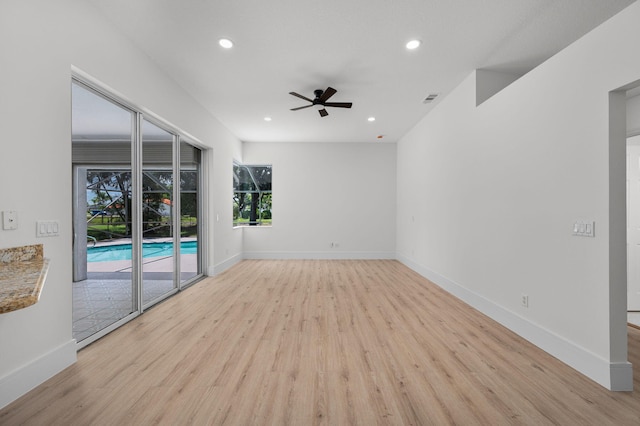 2707 SE Rawlings Rd, Port Saint Lucie, FL 34952 - unfurnished room featuring a ceiling fan, light wood finished floors, recessed lighting, and baseboards