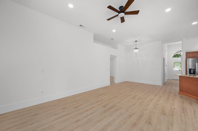 2707 SE Rawlings Rd, Port Saint Lucie, FL 34952 - unfurnished living room with a ceiling fan, light wood-style flooring, recessed lighting, and baseboards