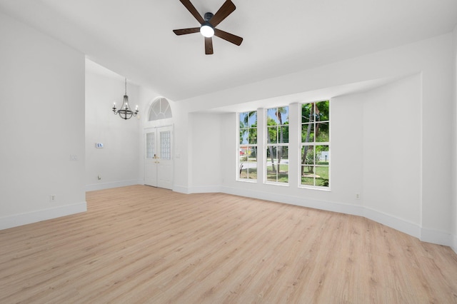 2707 SE Rawlings Rd, Port Saint Lucie, FL 34952 - unfurnished room featuring a chandelier, light wood-style flooring, baseboards, a ceiling fan, and lofted ceiling