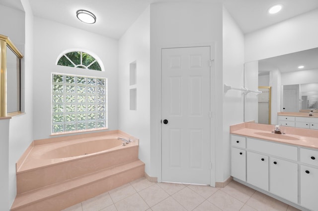 2707 SE Rawlings Rd, Port Saint Lucie, FL 34952 - full bathroom featuring vanity, healthy amount of natural light, a garden tub, tile patterned floors, and recessed lighting