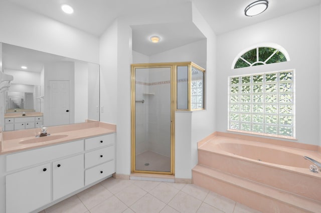 2707 SE Rawlings Rd, Port Saint Lucie, FL 34952 - bathroom featuring vanity, a stall shower, a garden tub, tile patterned floors, and lofted ceiling