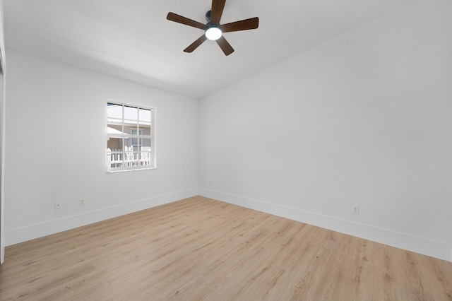 2707 SE Rawlings Rd, Port Saint Lucie, FL 34952 - empty room featuring wood finished floors, a ceiling fan, and baseboards