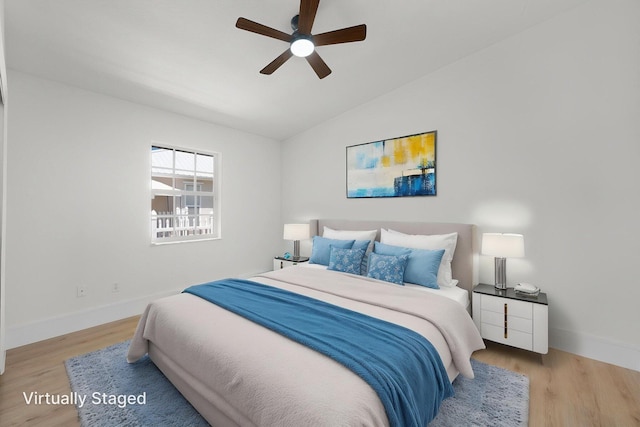 2707 SE Rawlings Rd, Port Saint Lucie, FL 34952 - bedroom featuring lofted ceiling, wood finished floors, baseboards, and a ceiling fan