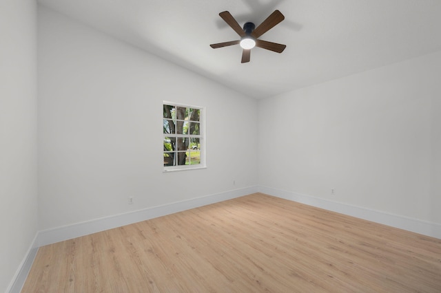 2707 SE Rawlings Rd, Port Saint Lucie, FL 34952 - spare room with wood finished floors, ceiling fan, vaulted ceiling, and baseboards