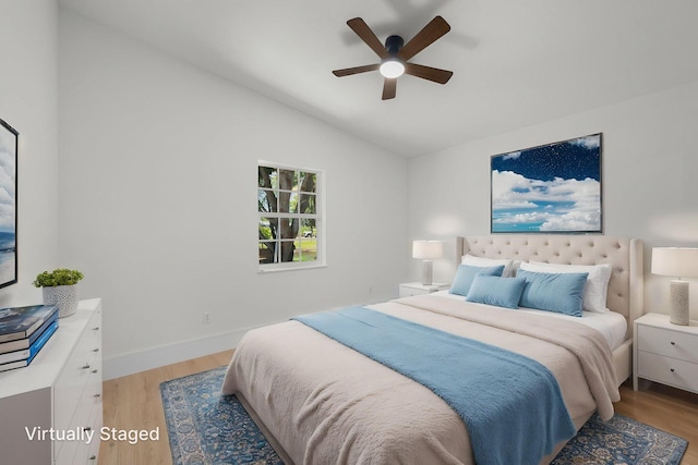 2707 SE Rawlings Rd, Port Saint Lucie, FL 34952 - bedroom featuring light wood-type flooring, vaulted ceiling, a ceiling fan, and baseboards