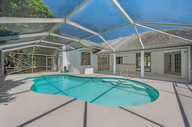 2707 SE Rawlings Rd, Port Saint Lucie, FL 34952 - outdoor pool with french doors, a patio, and a lanai