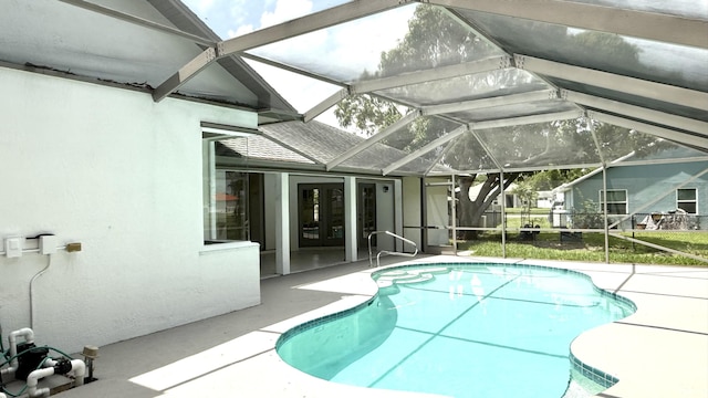 2707 SE Rawlings Rd, Port Saint Lucie, FL 34952 - outdoor pool with french doors, a patio, and glass enclosure