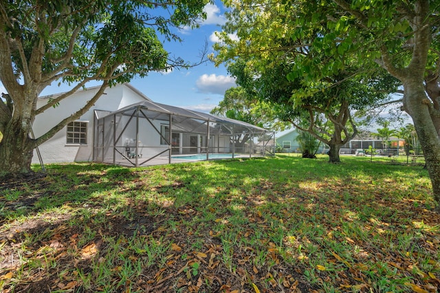 2707 SE Rawlings Rd, Port Saint Lucie, FL 34952 - view of yard featuring an outdoor pool and a lanai
