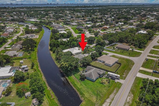 2707 SE Rawlings Rd, Port Saint Lucie, FL 34952 - aerial view of property and surrounding area with a large body of water and nearby suburban area