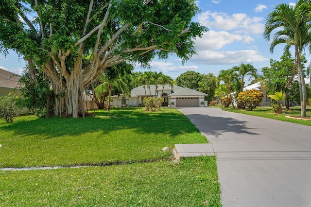 2707 SE Rawlings Rd, Port Saint Lucie, FL 34952 - view of front of property featuring a garage, driveway, and a front lawn