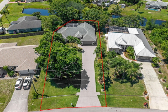 2707 SE Rawlings Rd, Port Saint Lucie, FL 34952 - aerial view of residential area with a large body of water and property parcel outlined