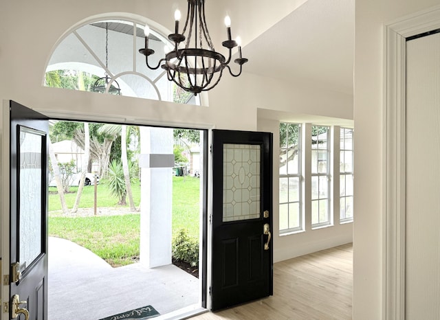 2707 SE Rawlings Rd, Port Saint Lucie, FL 34952 - foyer featuring a chandelier and light wood-type flooring