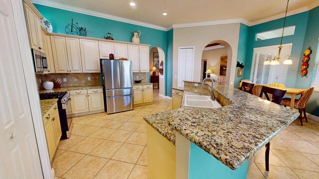 11206 SW Apple Blossom Trl, Port Saint Lucie, FL 34987 - kitchen with stainless steel appliances, arched walkways, a sink, light tile patterned flooring, and a breakfast bar area