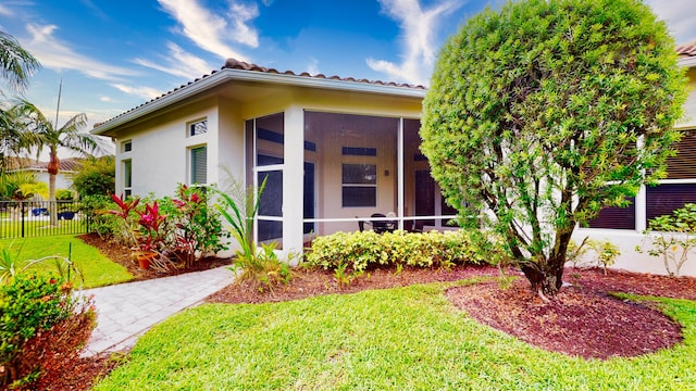 11206 SW Apple Blossom Trl, Port Saint Lucie, FL 34987 - view of property exterior with a sunroom, stucco siding, and a tiled roof