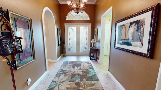 11206 SW Apple Blossom Trl, Port Saint Lucie, FL 34987 - foyer with french doors, ornamental molding, light tile patterned floors, a chandelier, and baseboards