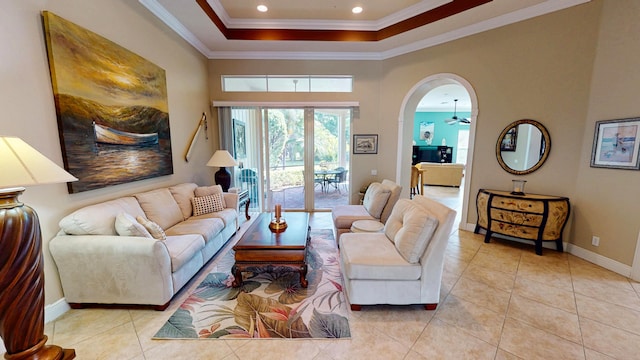 11206 SW Apple Blossom Trl, Port Saint Lucie, FL 34987 - living area featuring light tile patterned flooring, a tray ceiling, crown molding, baseboards, and arched walkways