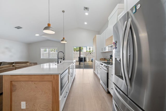 2540 NW 80th Ave, Margate, FL 33063 - kitchen featuring appliances with stainless steel finishes, lofted ceiling, open floor plan, a center island with sink, and white cabinetry