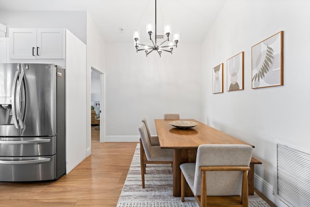2540 NW 80th Ave, Margate, FL 33063 - dining room with a chandelier, light wood-style flooring, and baseboards