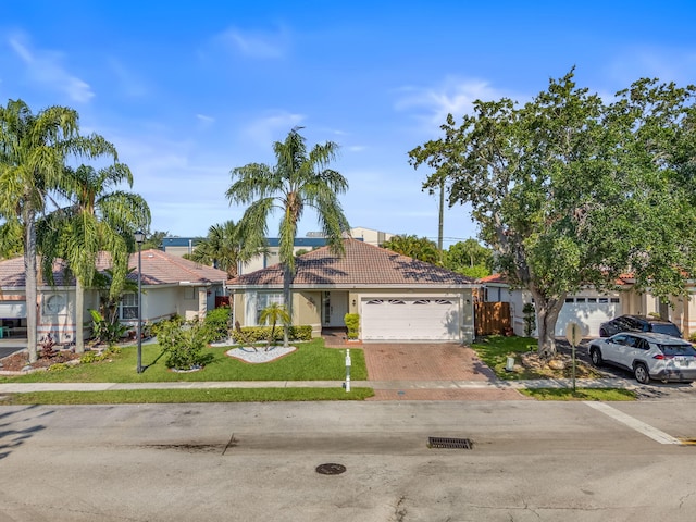 2540 NW 80th Ave, Margate, FL 33063 - view of front of house featuring a garage, a front yard, driveway, and a tiled roof