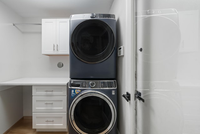 2540 NW 80th Ave, Margate, FL 33063 - laundry area with estacked washer and dryer, cabinet space, and baseboards