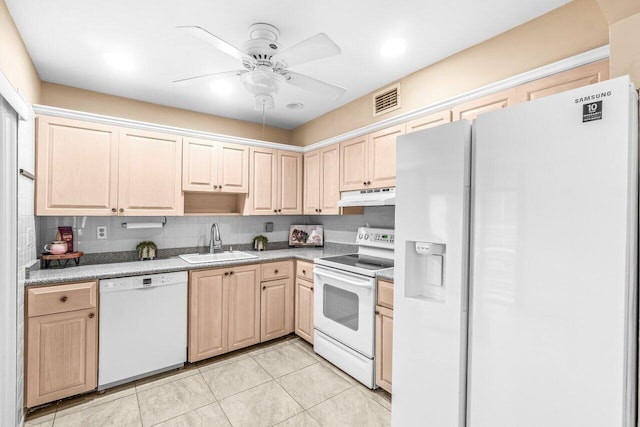 35 Capri A Unit A, Delray Beach, FL 33484 - kitchen with white appliances, a sink, under cabinet range hood, light brown cabinets, and ceiling fan