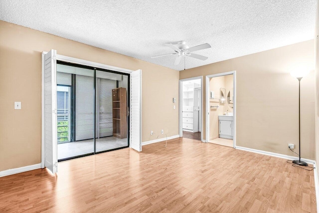 35 Capri A Unit A, Delray Beach, FL 33484 - unfurnished bedroom featuring wood finished floors, baseboards, a textured ceiling, and a ceiling fan