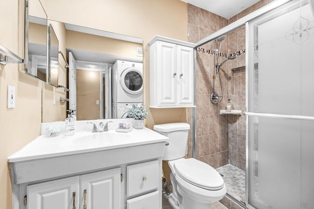 35 Capri A Unit A, Delray Beach, FL 33484 - bathroom featuring stacked washer / drying machine, a stall shower, toilet, and vanity