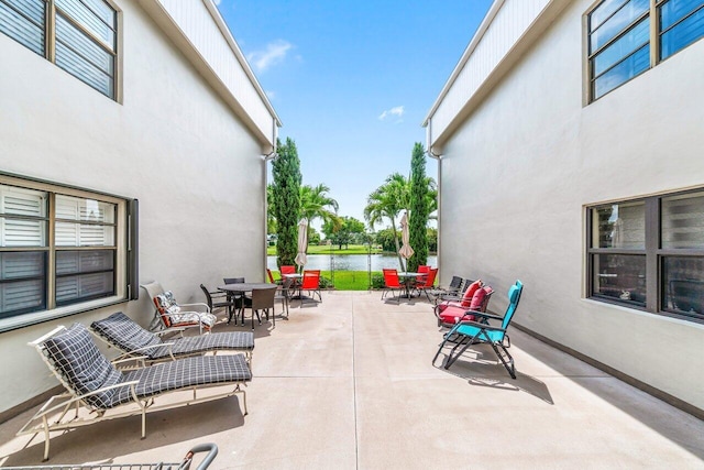 35 Capri A Unit A, Delray Beach, FL 33484 - view of patio with outdoor dining area and a water view