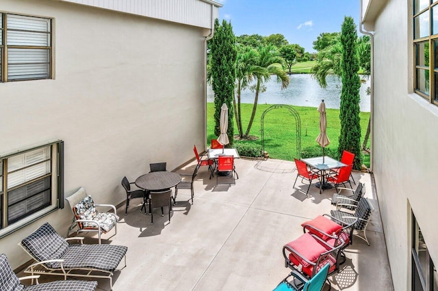 35 Capri A Unit A, Delray Beach, FL 33484 - view of patio with outdoor dining space and a water view