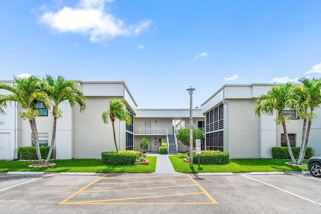35 Capri A Unit A, Delray Beach, FL 33484 - view of property featuring uncovered parking and stairs