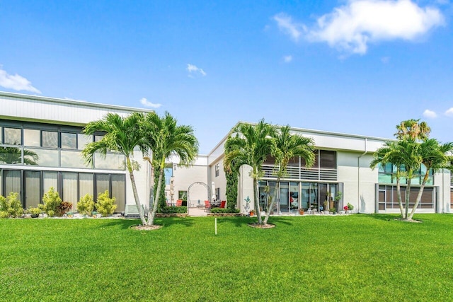 35 Capri A Unit A, Delray Beach, FL 33484 - back of house with stucco siding and a yard