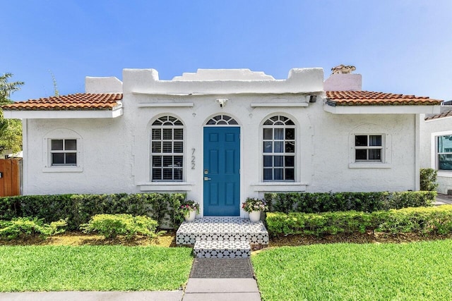 722 Valley Forge Rd, West Palm Beach, FL 33405 - view of front facade with a tile roof, stucco siding, and a chimney