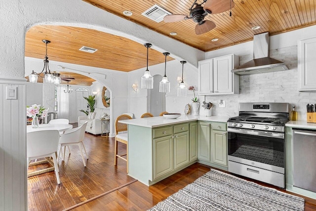 722 Valley Forge Rd, West Palm Beach, FL 33405 - kitchen with wall chimney range hood, stainless steel range with gas stovetop, green cabinets, wood ceiling, and ceiling fan