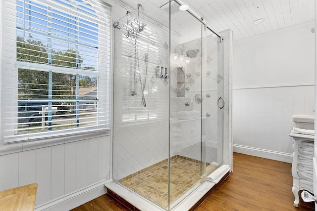 722 Valley Forge Rd, West Palm Beach, FL 33405 - bathroom featuring wood finished floors, a stall shower, baseboards, and wainscoting