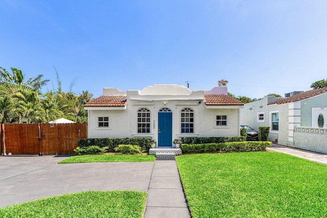 722 Valley Forge Rd, West Palm Beach, FL 33405 - mediterranean / spanish house with a tile roof, stucco siding, and a gate