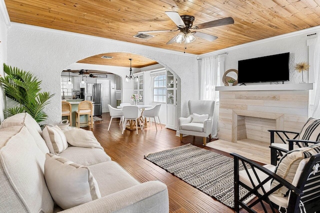 722 Valley Forge Rd, West Palm Beach, FL 33405 - living room with arched walkways, a ceiling fan, a textured wall, crown molding, and wooden ceiling