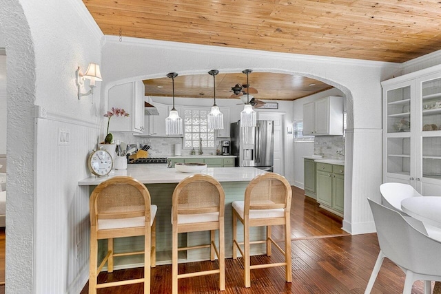 722 Valley Forge Rd, West Palm Beach, FL 33405 - kitchen with green cabinets, stainless steel fridge, wood ceiling, dark wood-style flooring, and crown molding